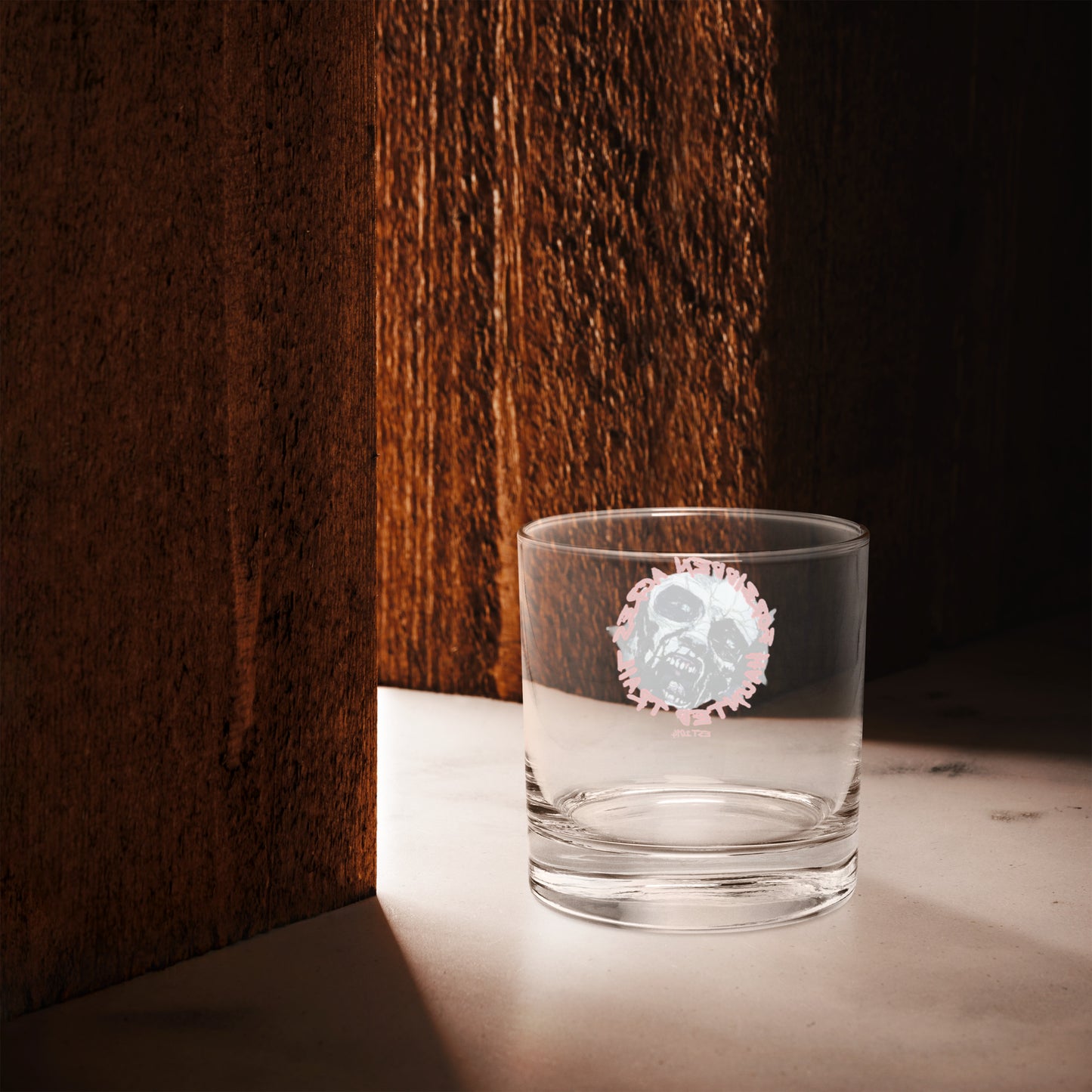 Rocks glass with Forbidden Acres Logo