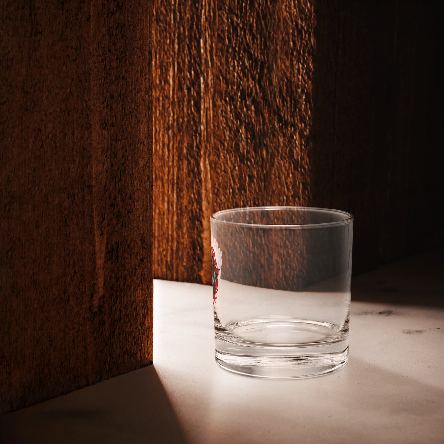Rocks glass with Forbidden Acres Logo